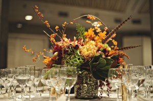 Fall wedding centerpiece with feathers.