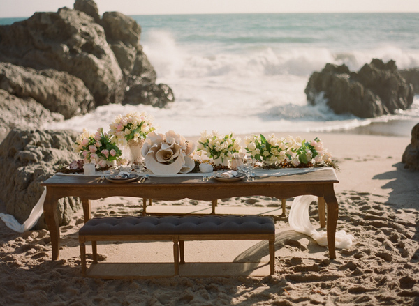 Table setting with muted floral bouquets for a beach wedding in Malibu California.