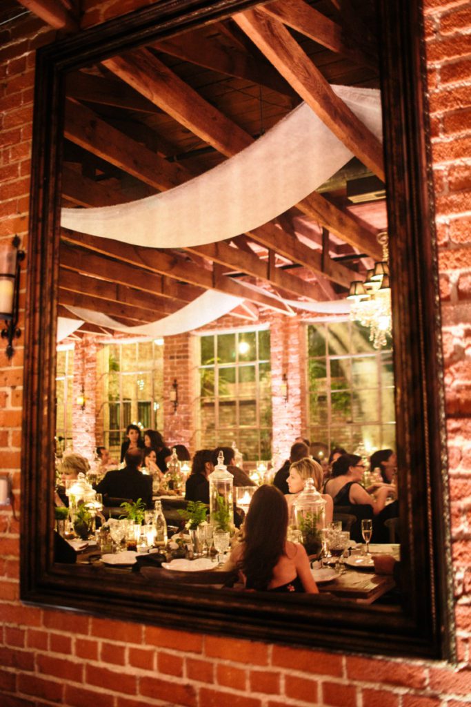 Wedding reception at Carondelet House captured in a mirror.