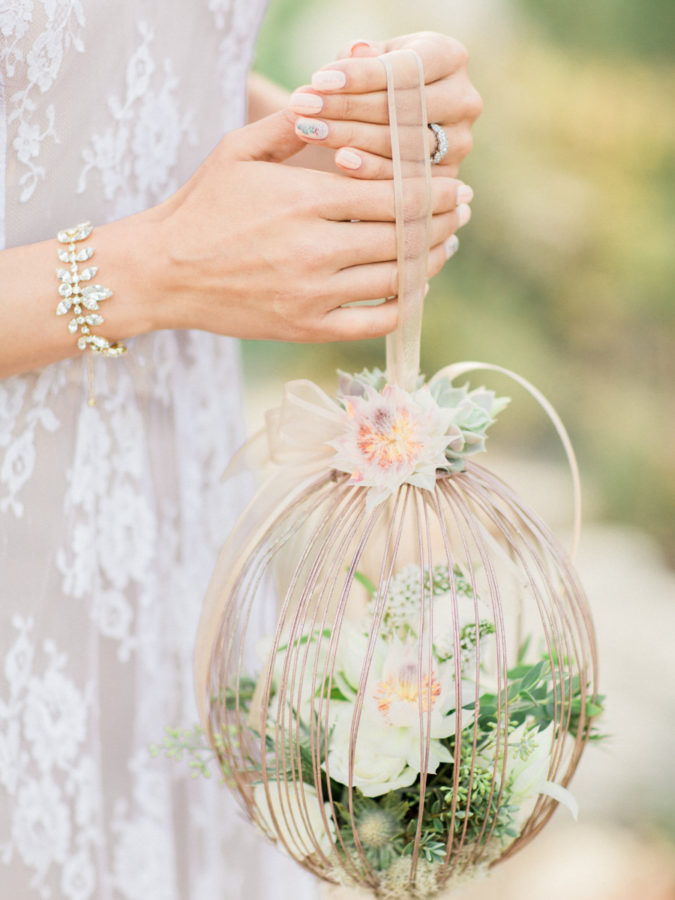 Close up of a romantic caged succulent bridal bouquet.