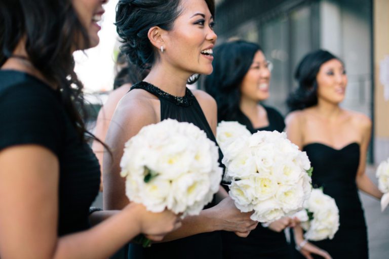 Close up of bridal party holding white wedding bouquets.