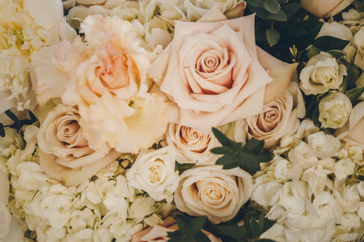 Close up of blush, cream and peach wedding flowers.
